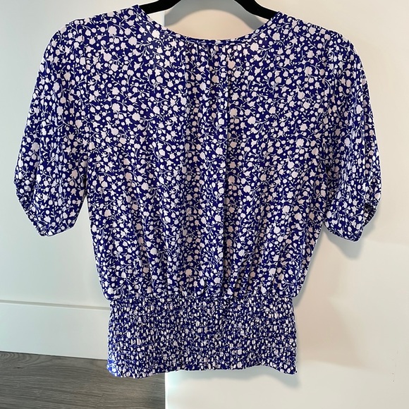 Faux wrap top with a snap closure & smocked at the  waist. - Picture 2 of 7